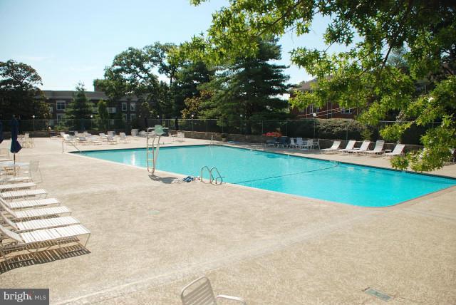 1200 North Nash Street, Unit 262 Arlington, VA 22209 - Photo 17 of 20 a view of a swimming pool with a yard
