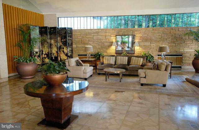 1200 North Nash Street, Unit 262 Arlington, VA 22209 - Photo 5 of 20 a living room with furniture and a fireplace