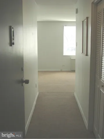 a room with a window and a cabinet