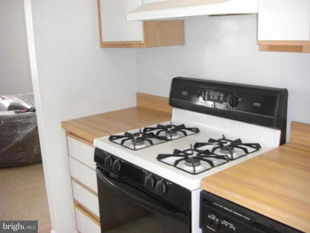 a kitchen with a stove and a refrigerator