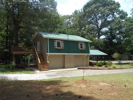 1011 Lee King Road Forsyth, GA 31029 - Photo 1 of 26 a house with trees in the background
