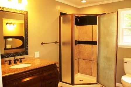 1011 Lee King Road Forsyth, GA 31029 - Photo 17 of 26 a bathroom with a granite countertop sink and a mirror