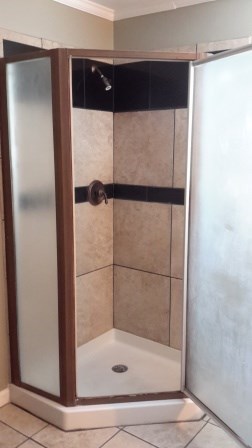1011 Lee King Road Forsyth, GA 31029 - Photo 18 of 26 a bathroom with a glass shower door