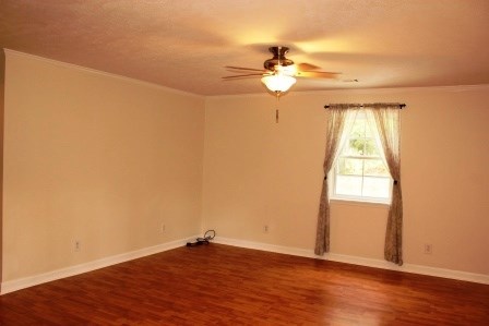 1011 Lee King Road Forsyth, GA 31029 - Photo 20 of 26 an empty room with wooden floor fan and windows