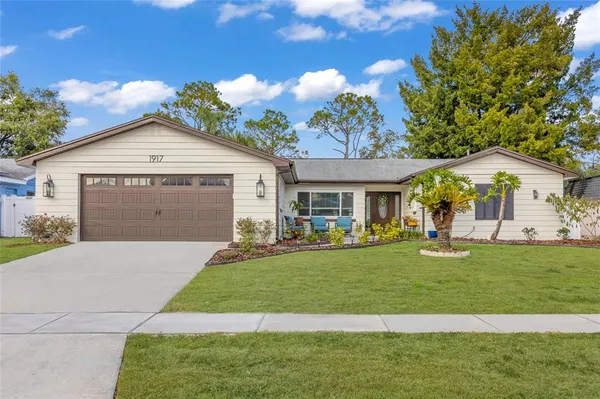 a front view of a house with a yard and garage