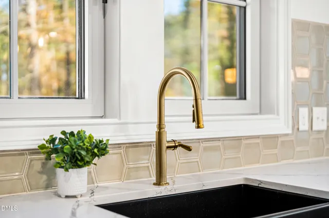 a dining hall with stainless steel appliances kitchen island granite countertop a dining table chairs and granite counter tops