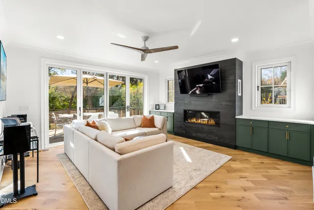a living room with furniture a rug and a fireplace