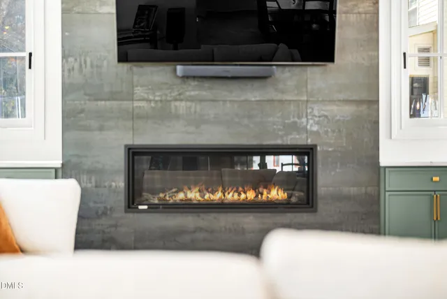 a living room with fireplace furniture and a flat screen tv