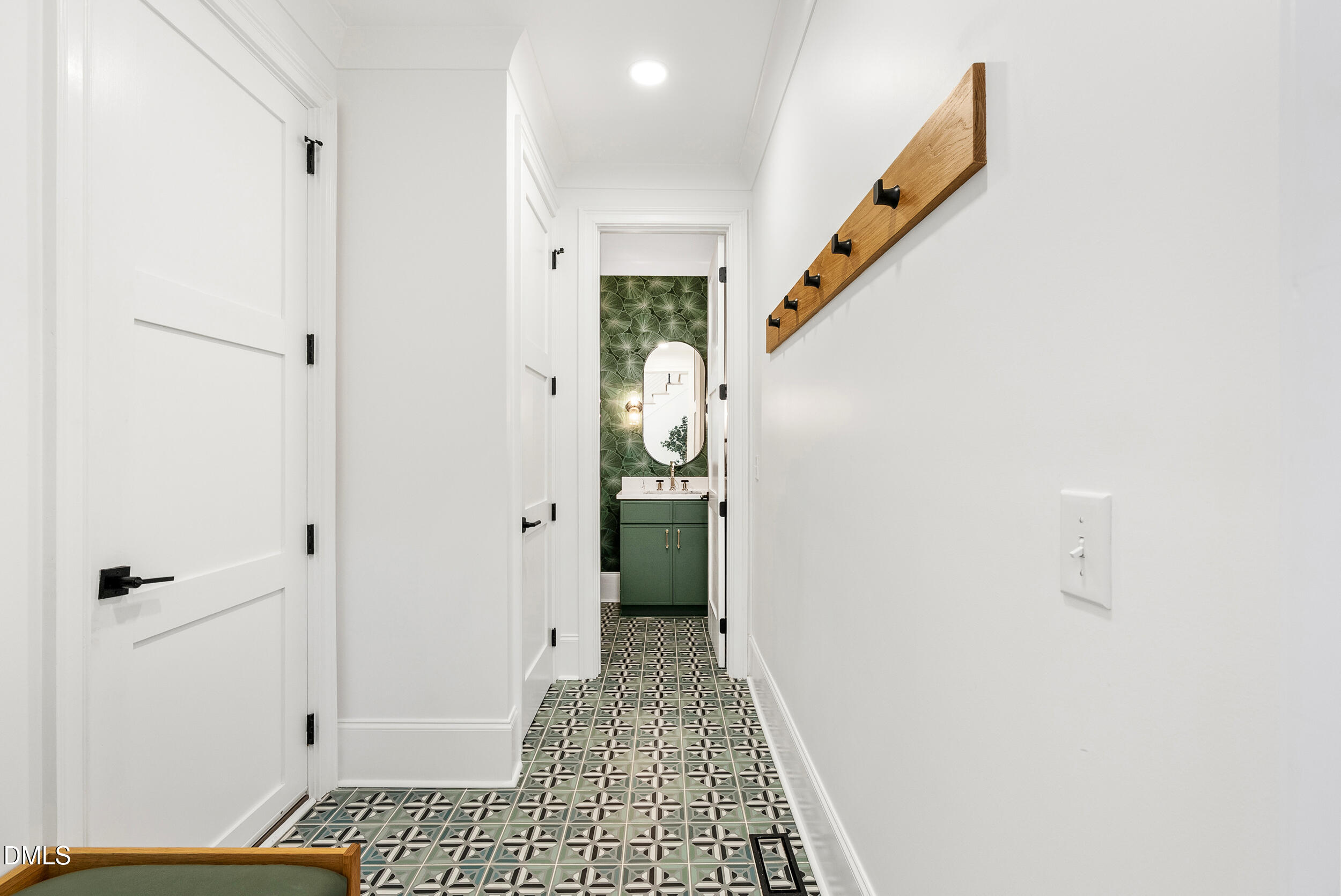 1232 Somerset Road Raleigh, NC 27610 - Photo 20 of 57 a view of a hallway with wooden floor and a bathroom