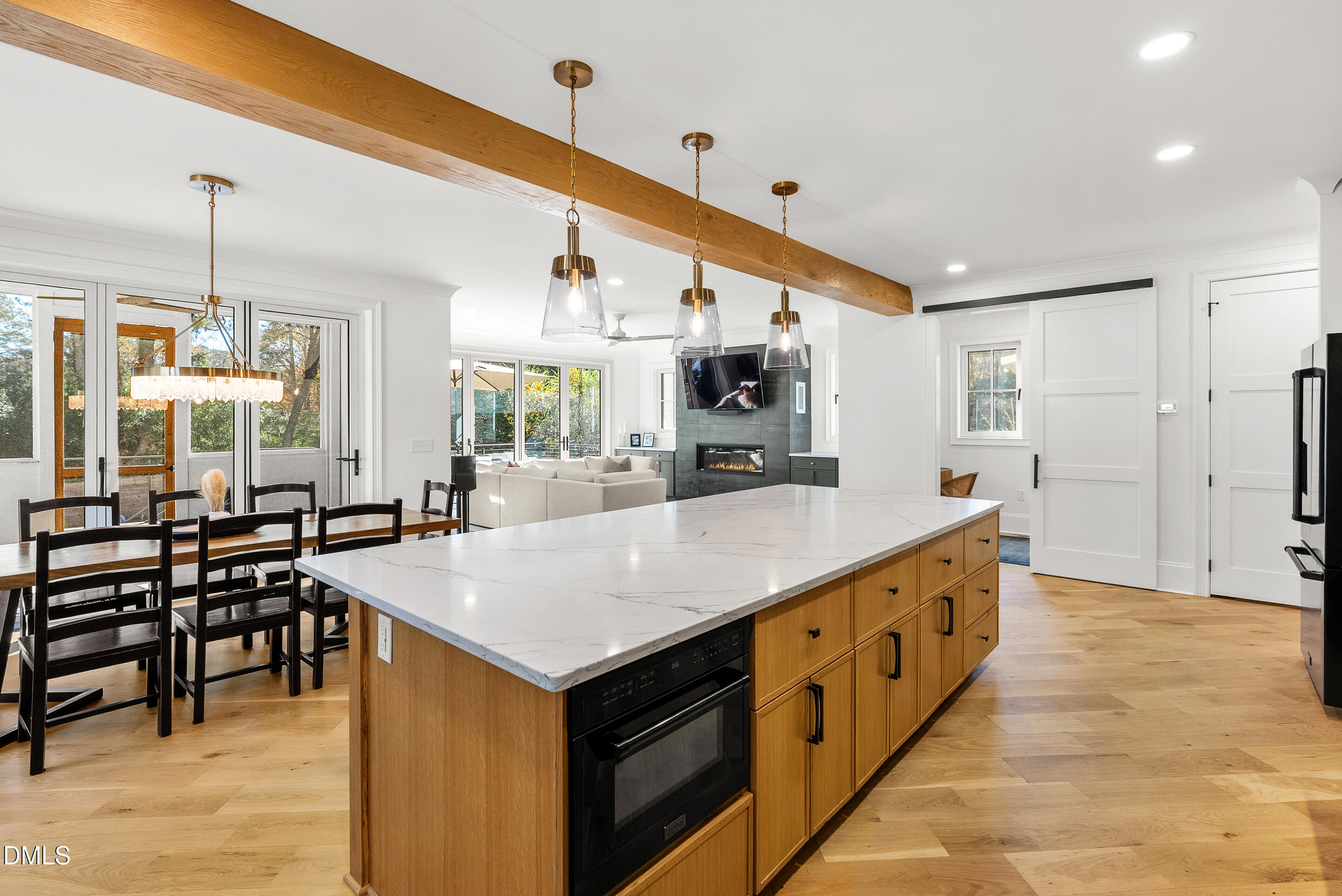 1232 Somerset Road Raleigh, NC 27610 - Photo 2 of 46 a large kitchen with kitchen island a large counter space a sink appliances and living room view