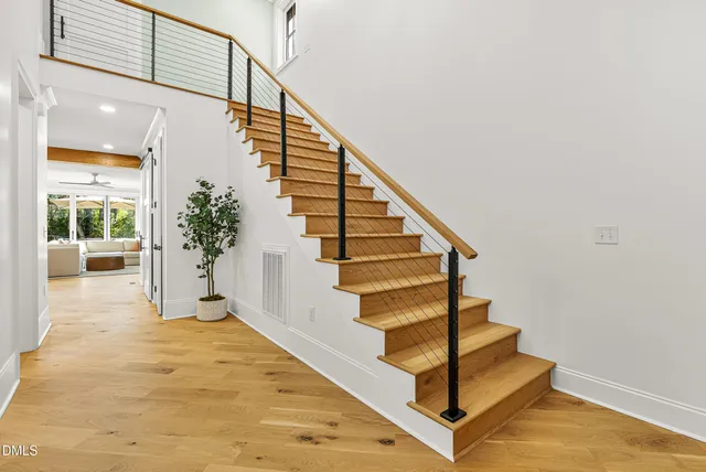 a view of entryway and hall with wooden floor