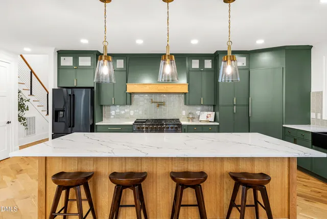a kitchen with granite countertop a stove and a microwave