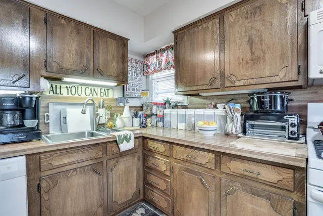 a living room with furniture a fireplace and a large window