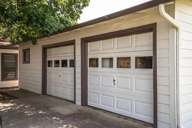 a view of a chair and table in backyard of the house