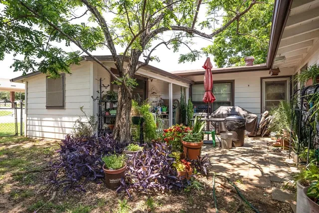 a backyard of a house with yard and outdoor seating
