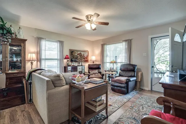 a living room with furniture fireplace and a large window