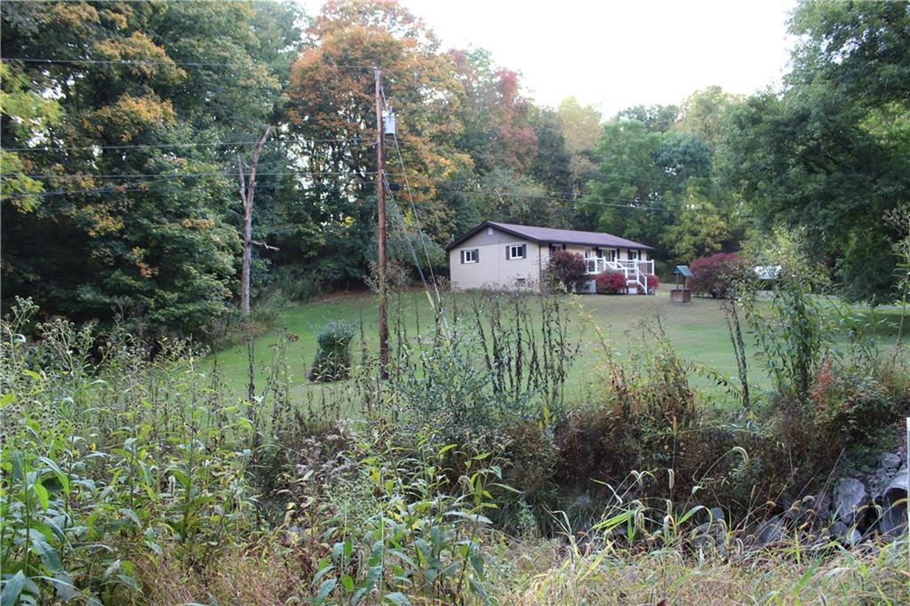 240 State Line Road Burgettstown, PA 15021 - Photo 33 of 42 a backyard of a house with lots of green space and fountain