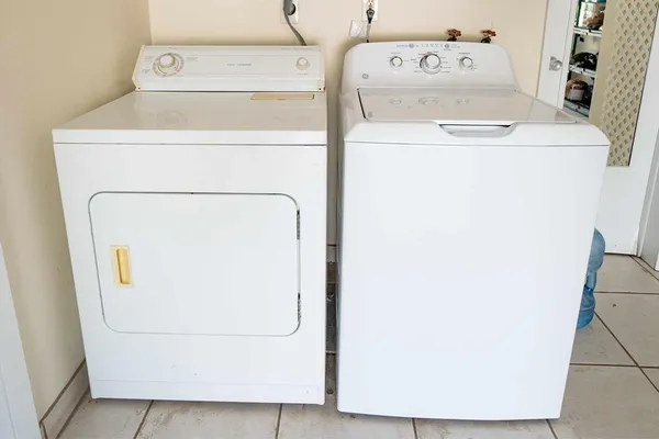 a white toilet sitting next to a white sink
