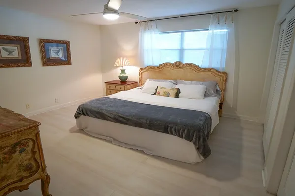 a bedroom with a large bed and a couch