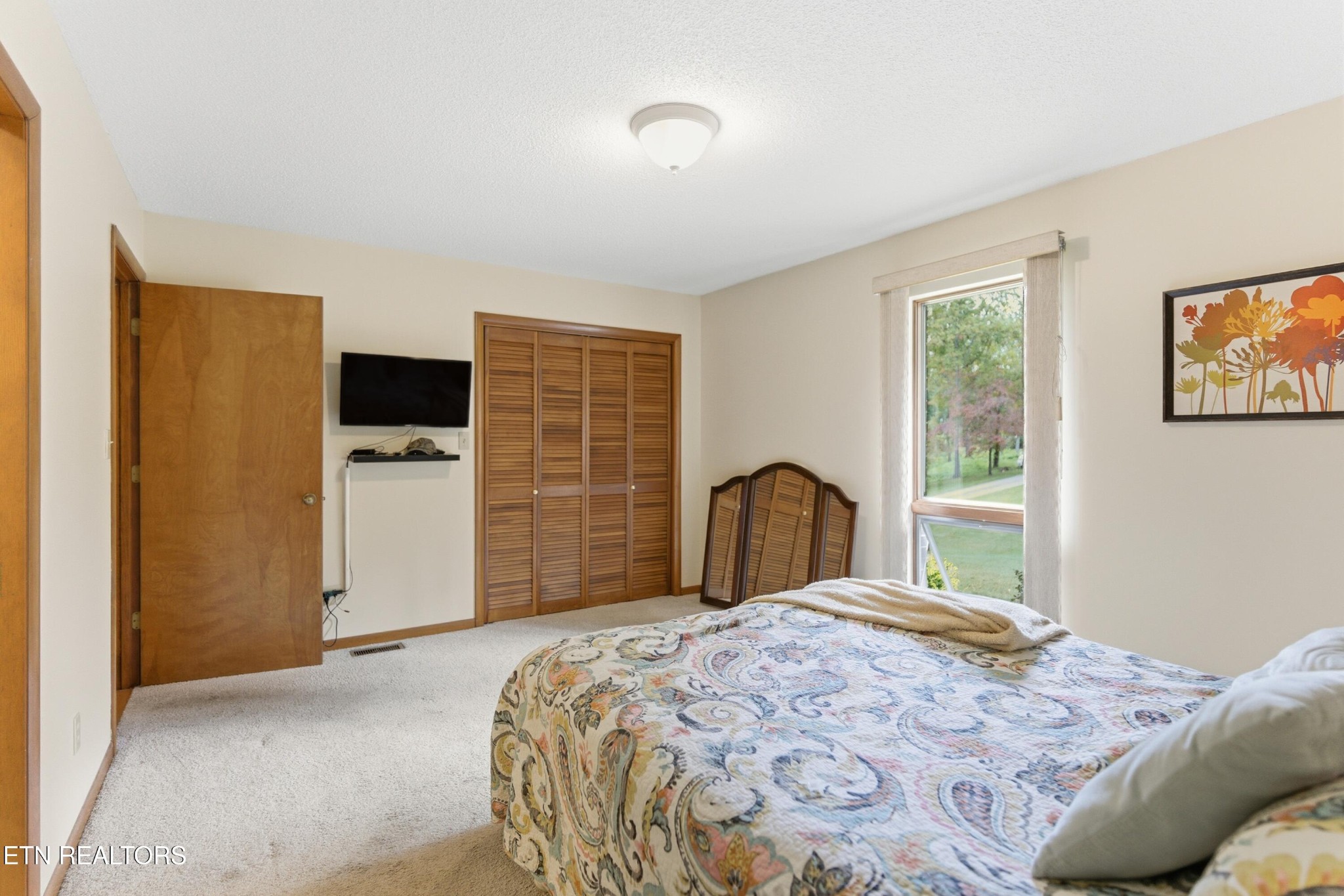 122 Fox Hunter Road Maynardville, TN 37807 - Photo 24 of 60 a bedroom with a bed and a flat screen tv