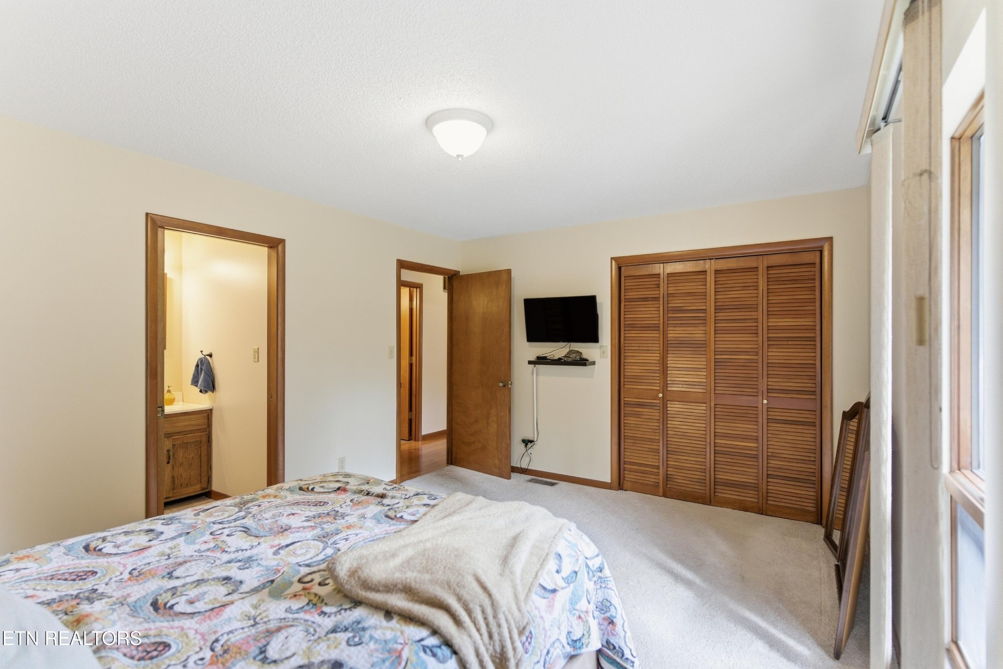 122 Fox Hunter Road Maynardville, TN 37807 - Photo 27 of 60 a bedroom with a bed and a flat screen tv