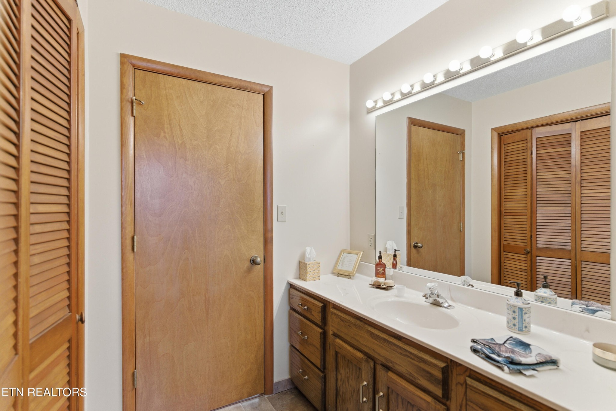 122 Fox Hunter Road Maynardville, TN 37807 - Photo 31 of 60 a bathroom with a double vanity sink and a mirror