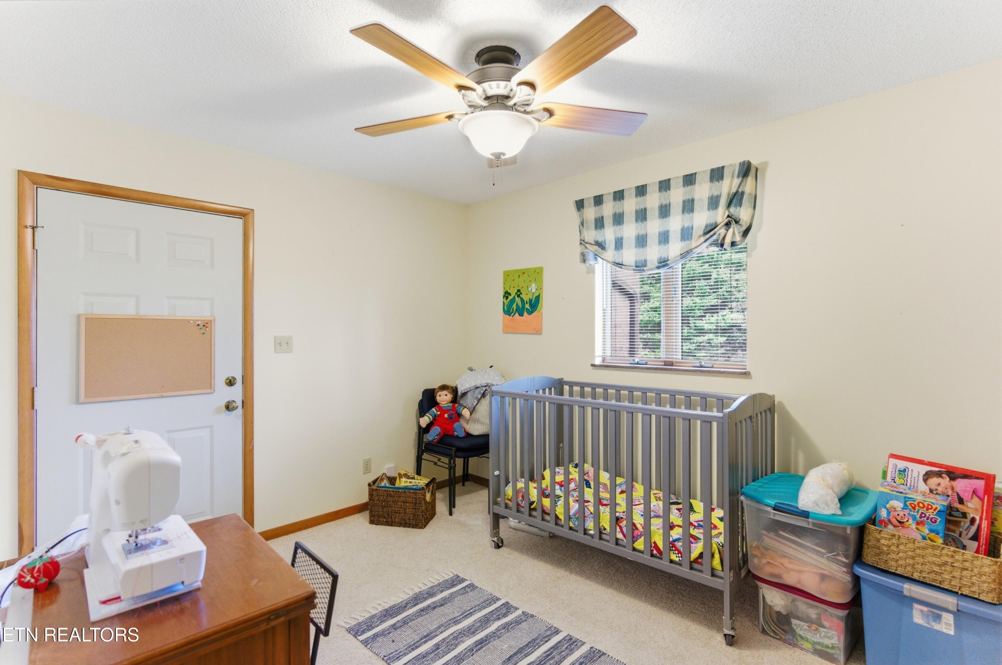 122 Fox Hunter Road Maynardville, TN 37807 - Photo 33 of 60 a bedroom with a bed and a chandelier