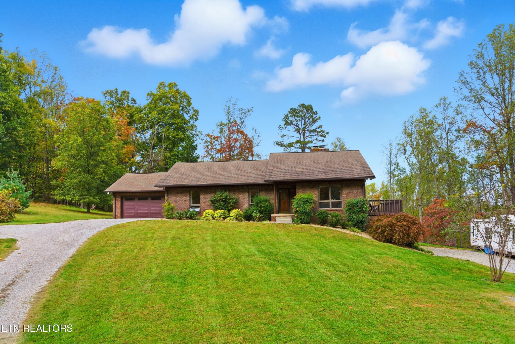 122 Fox Hunter Road Maynardville, TN 37807 - Photo 60 of 60 a view of a house with table and chairs under an umbrella
