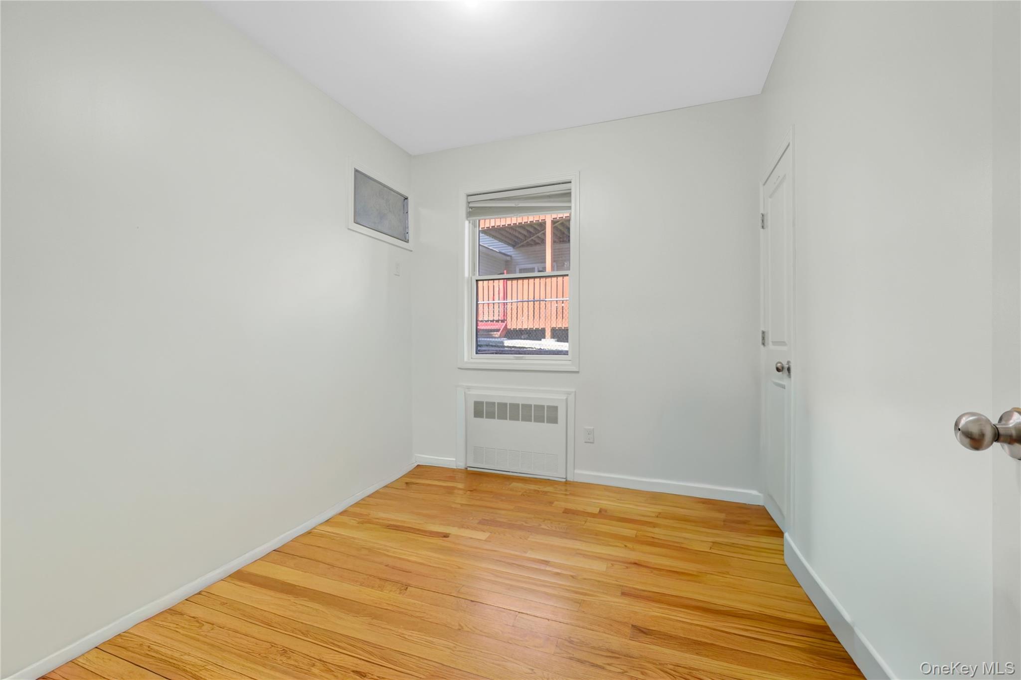 462 West Central Avenue, Unit 120 Spring Valley, NY 10977 - Photo 13 of 21 an empty room with wooden floor and windows