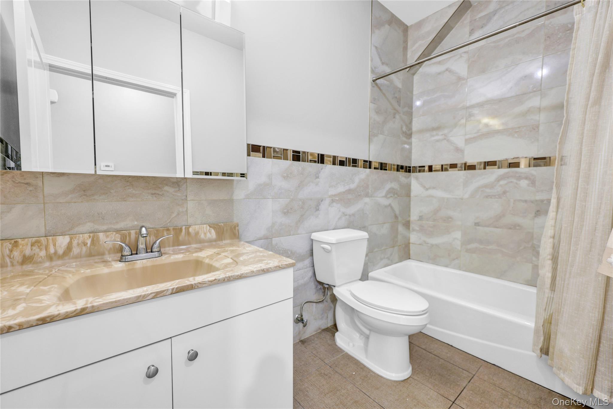 462 West Central Avenue, Unit 120 Spring Valley, NY 10977 - Photo 15 of 21 a bathroom with a granite countertop sink a toilet and shower