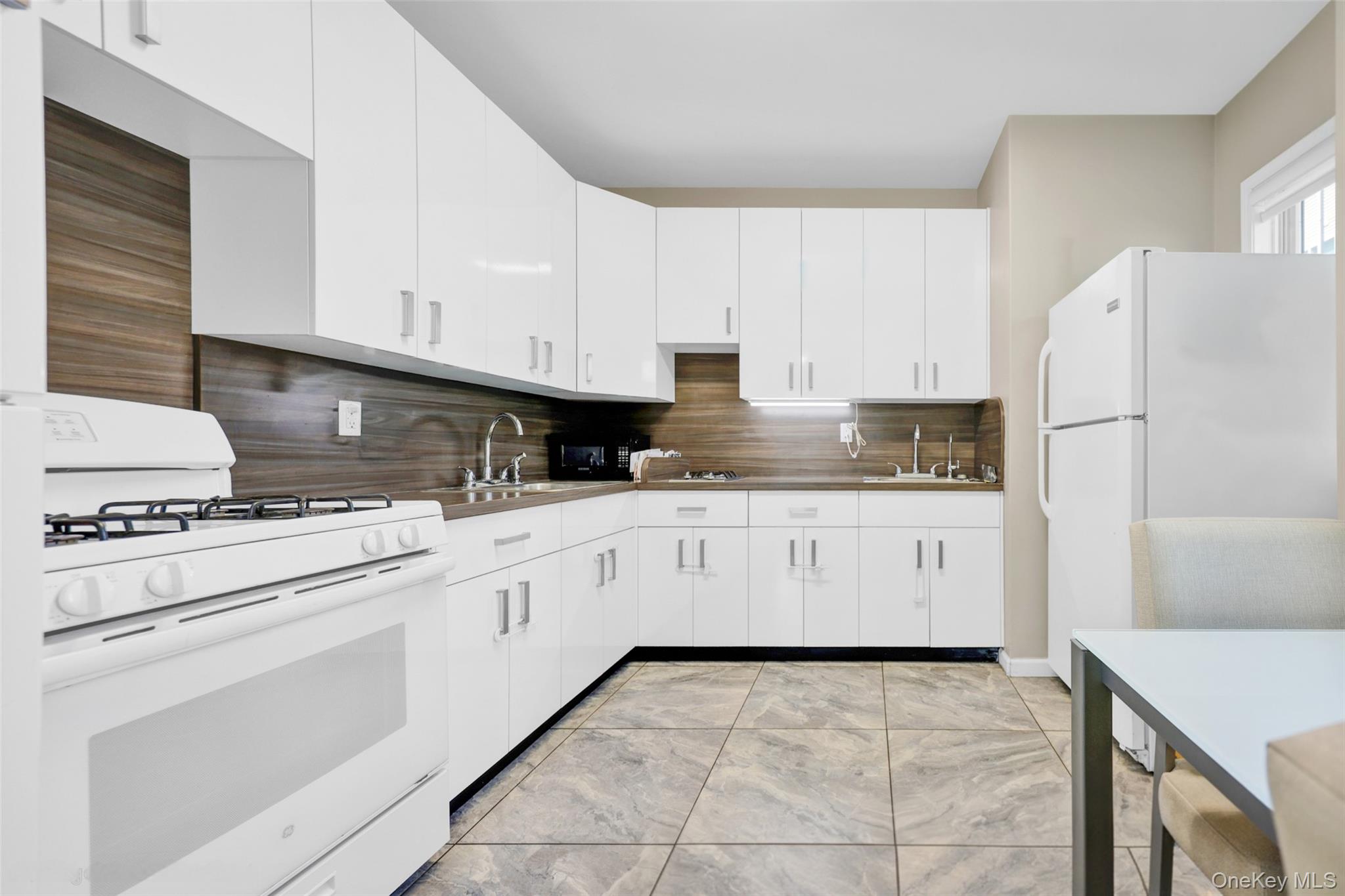 462 West Central Avenue, Unit 120 Spring Valley, NY 10977 - Photo 3 of 21 a kitchen with granite countertop white cabinets and white appliances
