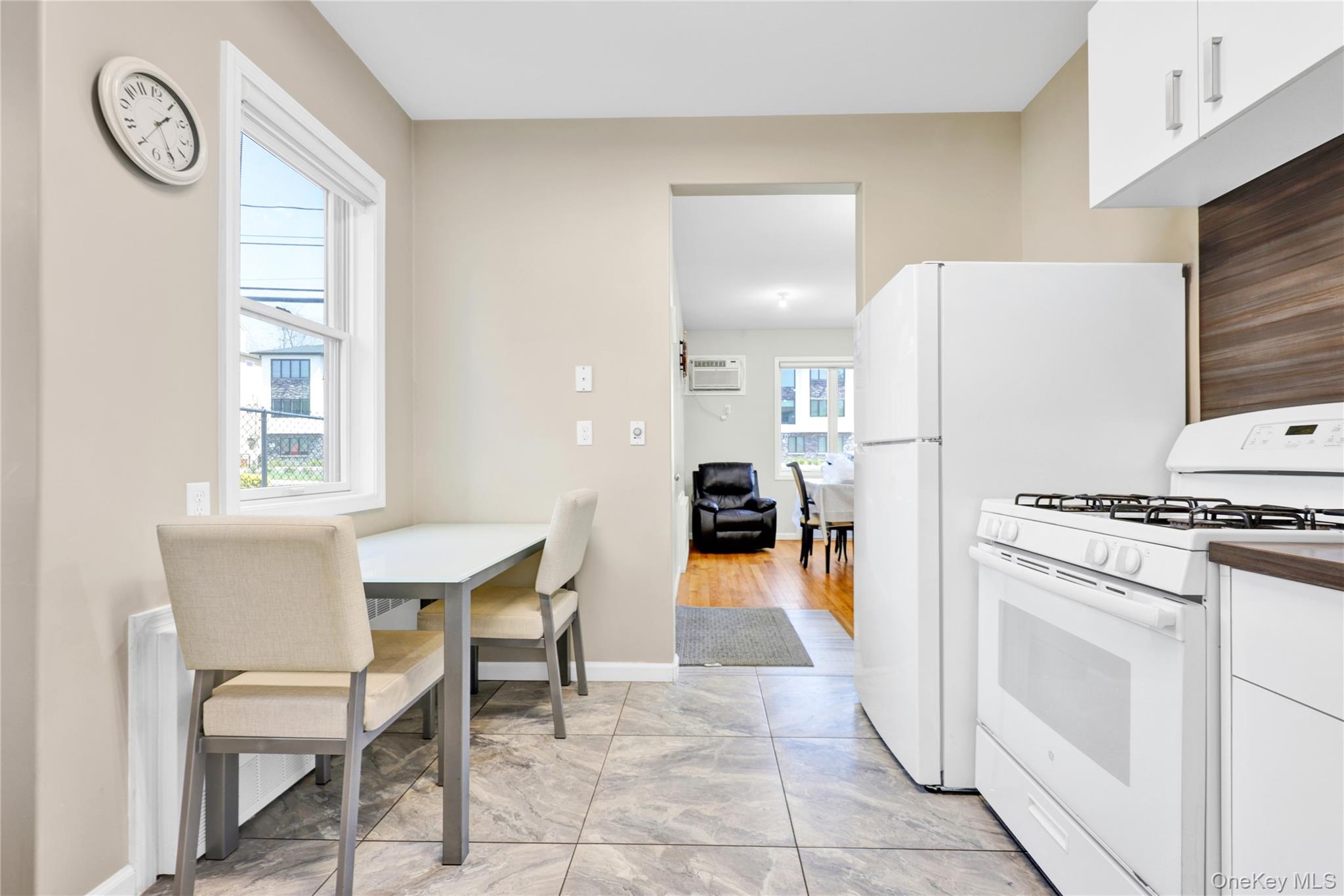 462 West Central Avenue, Unit 120 Spring Valley, NY 10977 - Photo 5 of 21 a kitchen with a table chairs and a refrigerator