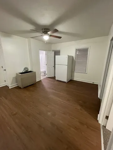 a living room with furniture and a ceiling fan