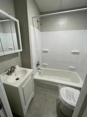 a bathroom with a sink a toilet and bathtub