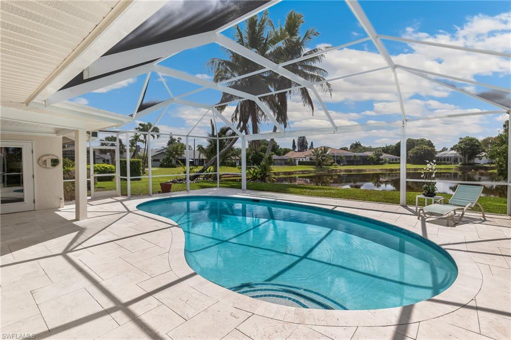 1904 Countess Court Naples, FL 34110 - Photo 27 of 33 a view of a swimming pool with a lounge chairs