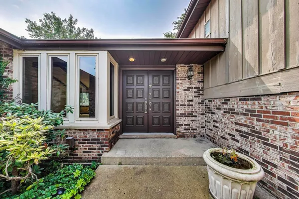 a front view of a house with a garden