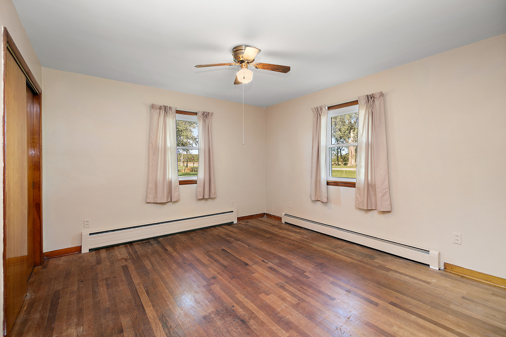 76 South 7000W Road Kankakee, IL 60901 - Photo 12 of 18 wooden floor in an empty room with a window