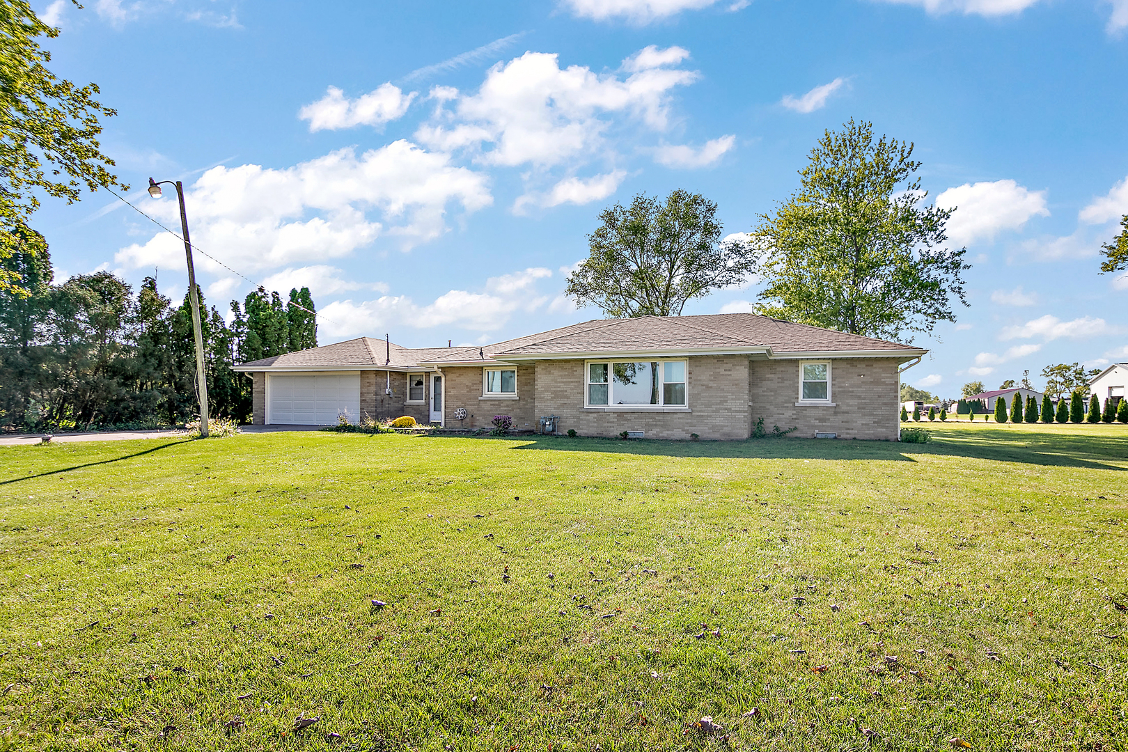 76 South 7000W Road Kankakee, IL 60901 - Photo 3 of 18 a front view of a house with a garden