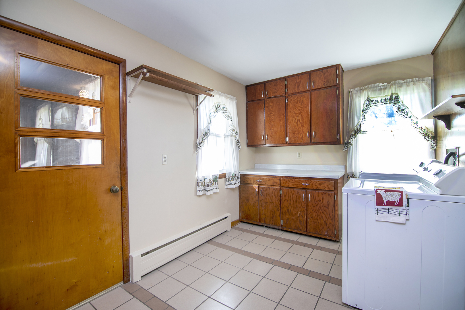 76 South 7000W Road Kankakee, IL 60901 - Photo 10 of 18 a kitchen with granite countertop a refrigerator a stove and wooden cabinets