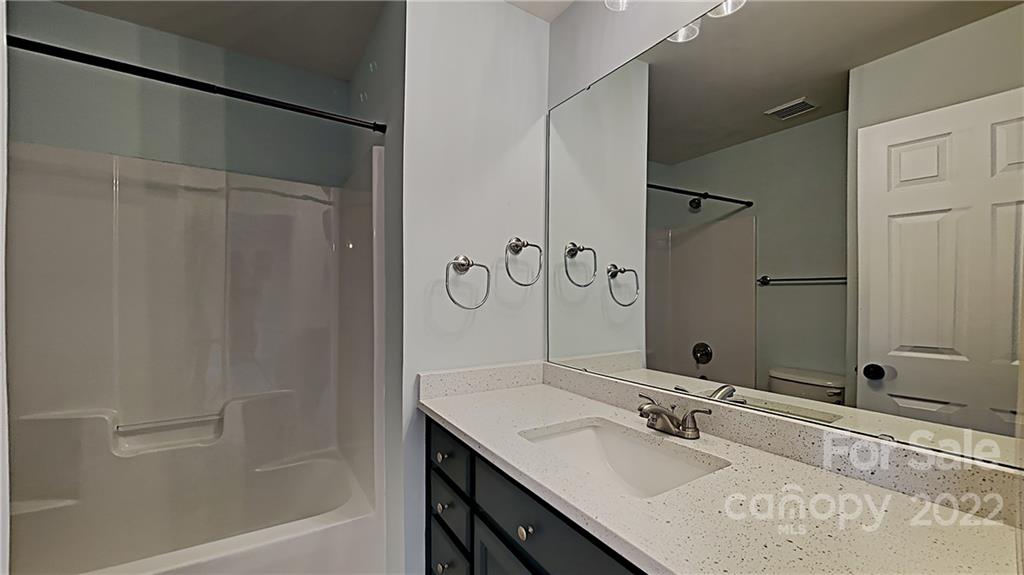 6415 Riverside Oaks Drive Huntersville, NC 28078 - Photo 15 of 22 a bathroom with a granite countertop sink and a mirror
