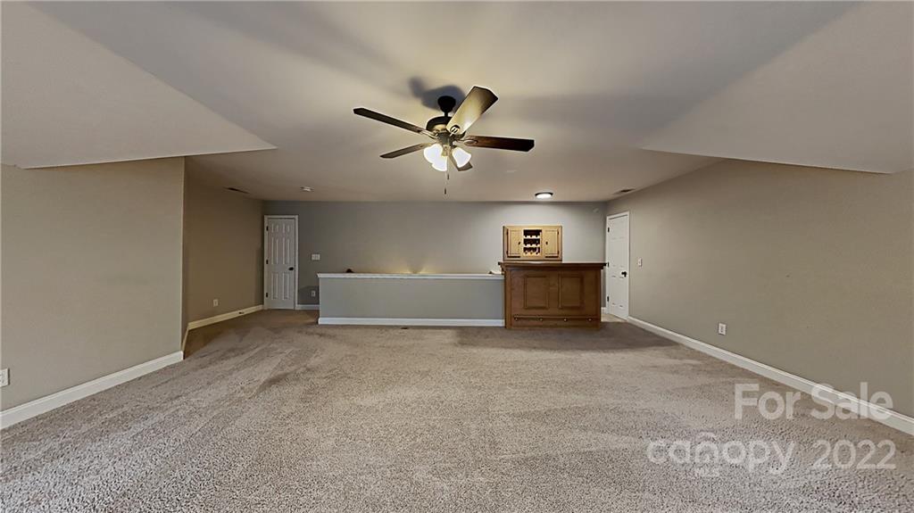 6415 Riverside Oaks Drive Huntersville, NC 28078 - Photo 21 of 22 a view of a livingroom with a ceiling fan and a workspace