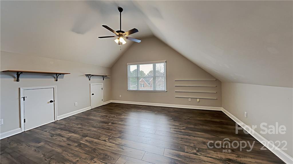 6415 Riverside Oaks Drive Huntersville, NC 28078 - Photo 5 of 22 a view of an empty room with a window and wooden floor