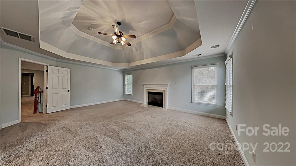 6415 Riverside Oaks Drive Huntersville, NC 28078 - Photo 7 of 22 en empty room with windows and fireplace