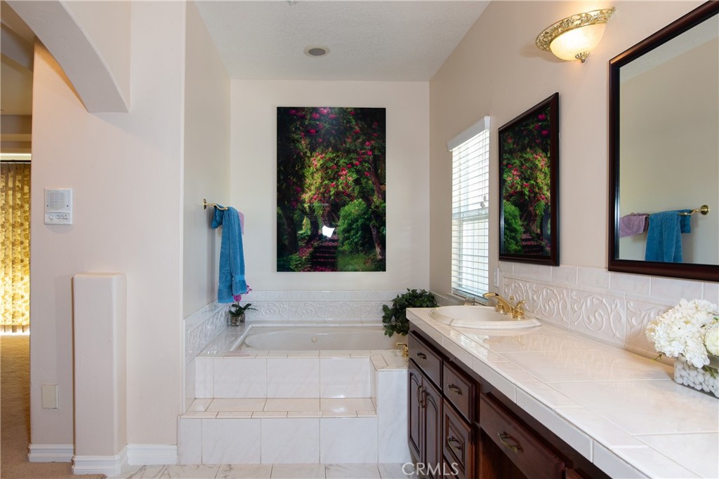 7361 Via Vista Riverside, CA 92506 - Photo 13 of 34 a spacious bathroom with a granite countertop tub and a sink
