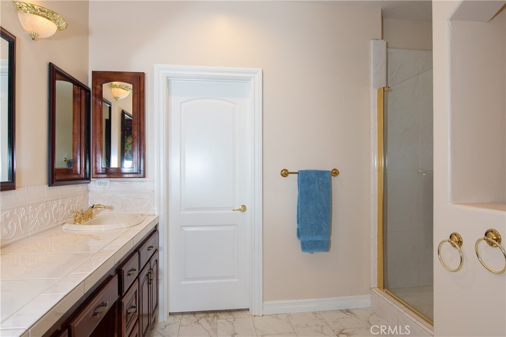 7361 Via Vista Riverside, CA 92506 - Photo 14 of 34 a bathroom with a granite countertop sink and a mirror