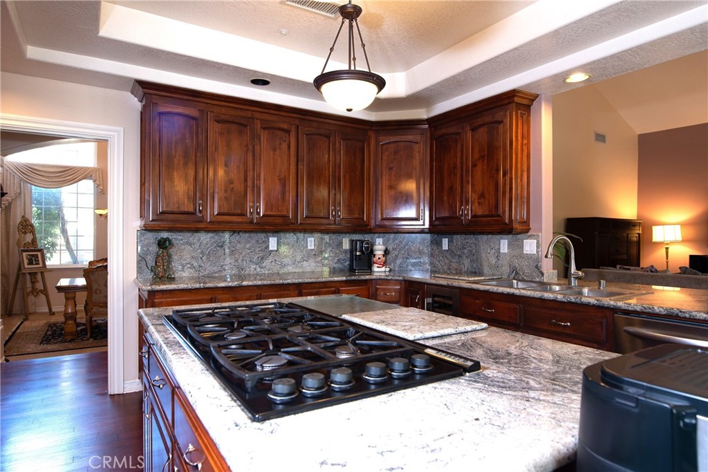 7361 Via Vista Riverside, CA 92506 - Photo 17 of 34 a kitchen with wooden cabinets and a stove top oven
