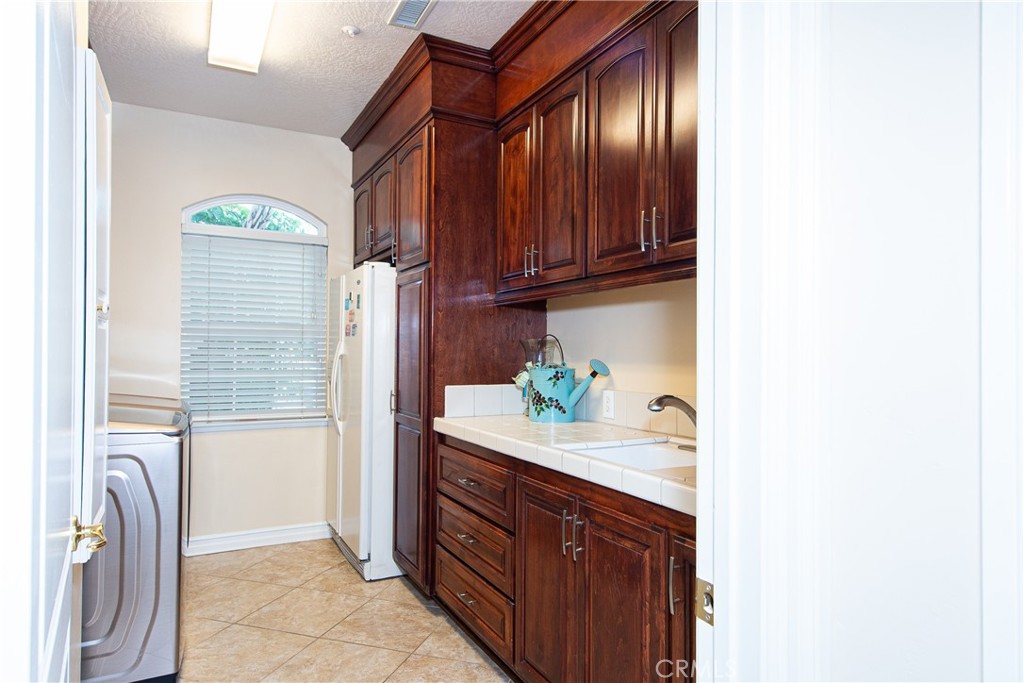 7361 Via Vista Riverside, CA 92506 - Photo 23 of 34 a bathroom with a granite countertop sink and a shower curtain