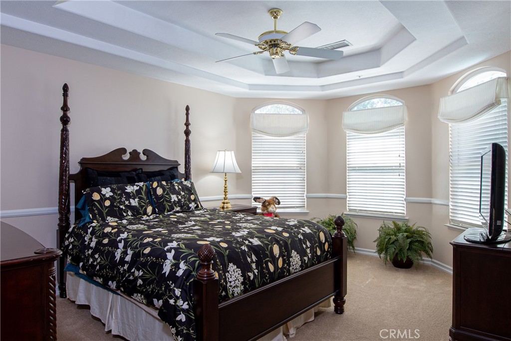 7361 Via Vista Riverside, CA 92506 - Photo 28 of 34 a bed sitting in a bedroom next to a window and a chandelier