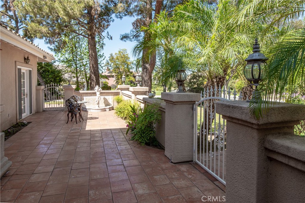 7361 Via Vista Riverside, CA 92506 - Photo 4 of 34 a view of a patio with dining table and chairs with wooden fence and plants
