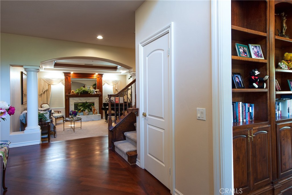7361 Via Vista Riverside, CA 92506 - Photo 6 of 34 a hallway with wooden floor and book shelf